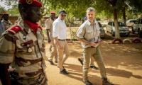 Image showing HRH Crown Prince Frederik of Denmark visiting Niger's national guard. Four men in image, trees in background