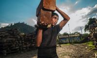 A man in Honduras carrying wood blocks. Photo: Unsplash