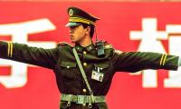 A Chinese policeman guides traffic